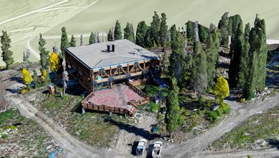 A 3D model of a building surrounded by trees